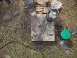 Diverse Eisenkügelchen... <br />(Schrot, bereits wieder in das Glas <br />mit grünem Deckel rts. eingefüllt),<br />sowie einige weich gewordene Glas-<br />scherben, in die sich o.g. Eisenschrot<br />abgedrückt haben...